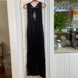 Deep cut, silky black dress with slit. Never been worn, tags attached